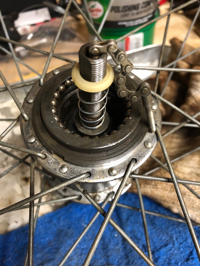 With each piece cleaned well, reassembly is, as they say, the reverse of disassembly. Here, the gear assembly, clutch, spring, nylon washer and hub end are all back in place.