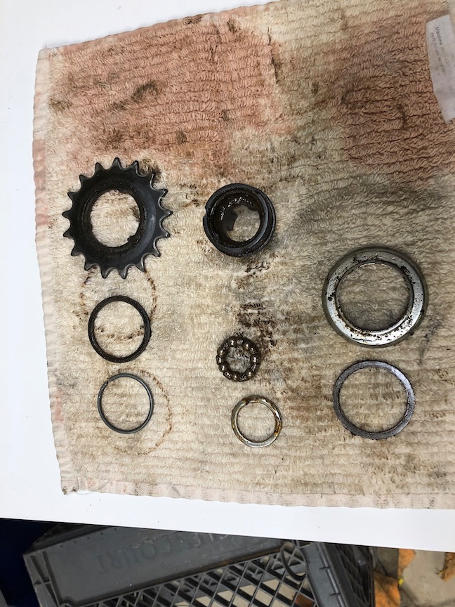 The sprocket assembly disassembled for cleaning and laid out in the order it should go back together. It's critically important to keep track of the order and orientation of each small piece.