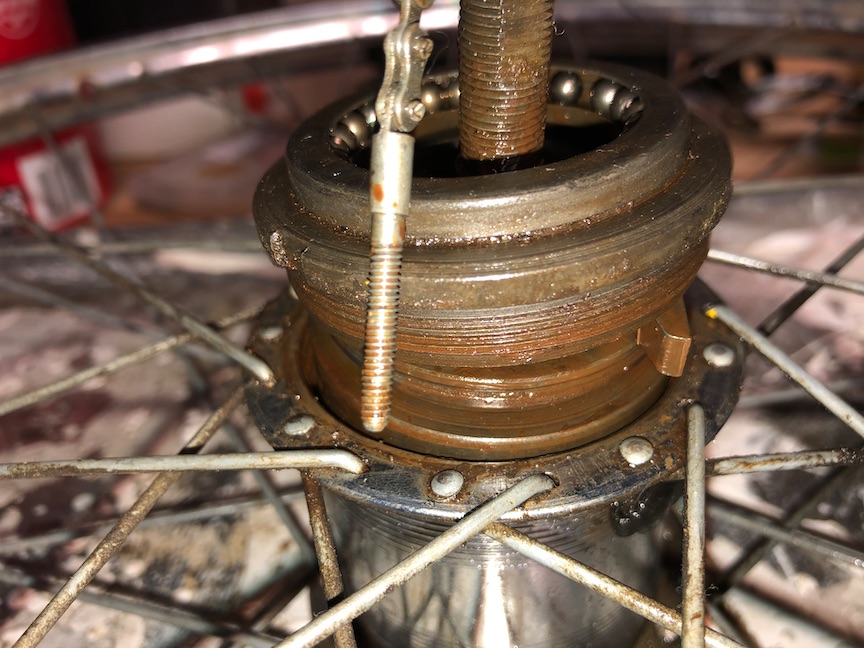 We can now open the hub fully, using the highly sophisticated 'hammer whacking on a screwdriver in the lockring slot cause we do not own the proper tool' method. If you haven't done it already, this is a good time to remove the non-drive-side cone and bearings. That's pretty straightforward.