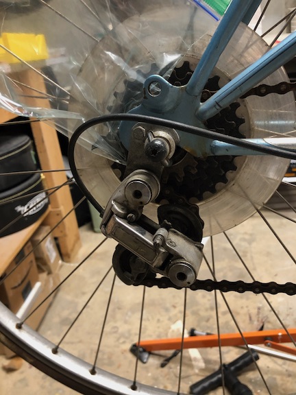 One reason it was so cheap: the chain was so rusty the Simplex derailleur had a broken jockey pulley after someone had attempted to force it to move. Luckily the prior owner had  kept the jockey pulley remnants in a ziploc bag helpfully taped to the rear wheel.
