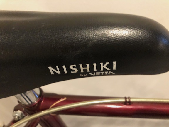 The original seat is still in place, and in good condition. Now, what am I going to do with a Nishiki-branded seat?